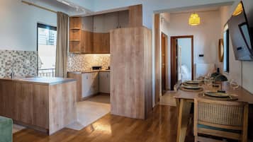 Apartment, Balcony, City View | Living area | 50-inch Smart TV with satellite channels, fireplace