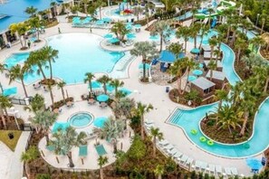 A resort with multiple swimming pools, palm trees, and lounge areas. - Family 5 Bdr Disney Villa w/ Private Pool & Resort (Davenport)