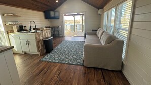 A cozy cabin interior with a kitchen, dining area, and a living room. - Cozy 101 Cabin 1 bdrm on Smith Lake Located beside Smith Lake Park Boat Ramp (Cullman)