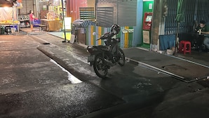 A street scene with a motorcycle parked in front of a closed shop with a green ATM sign. - Located at CBD Rama 9 convenience area. Private Room with Share bath (Krung Thep Maha Nakhon)