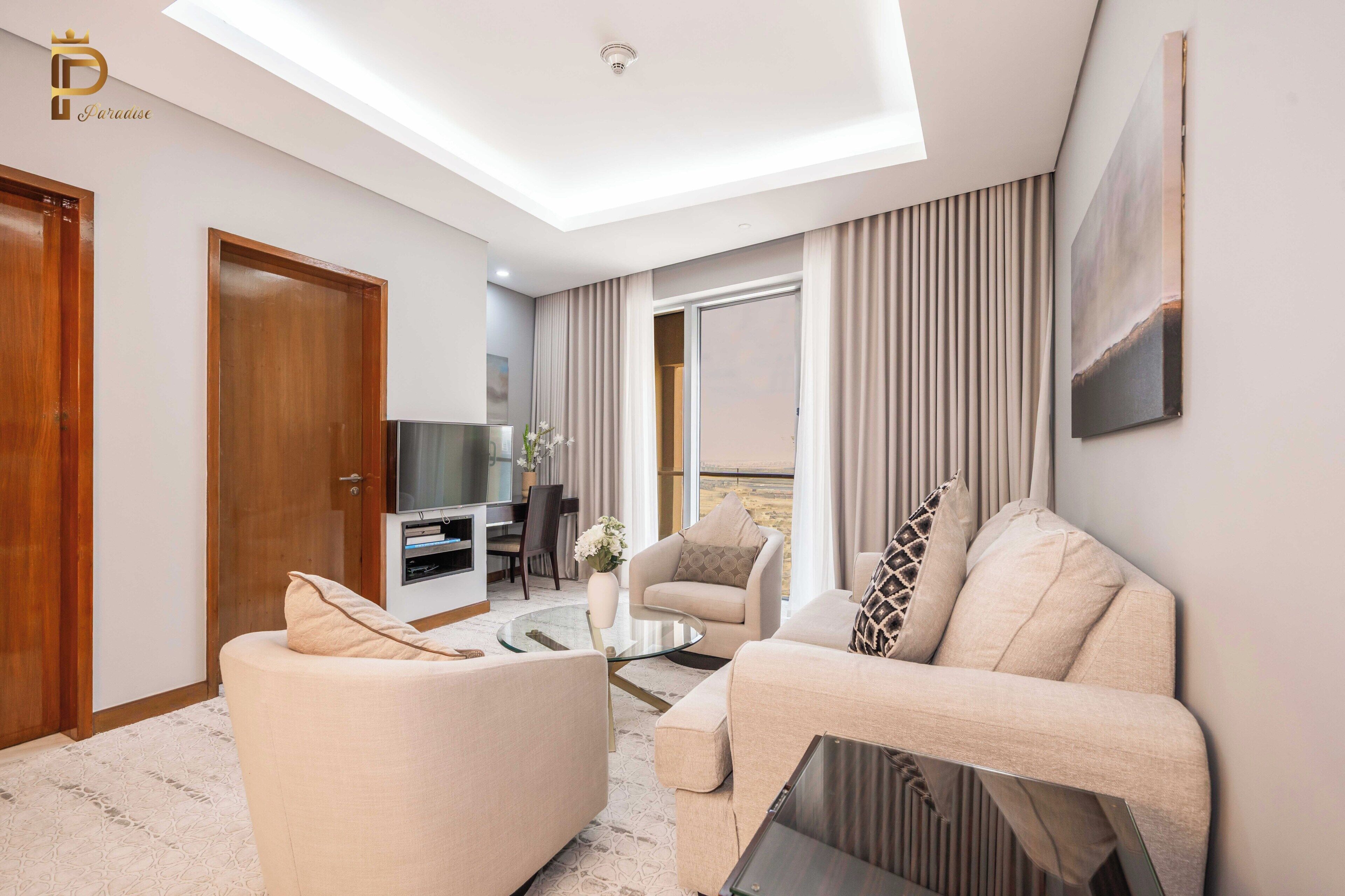 A modern living room with a sofa, coffee table, and television.