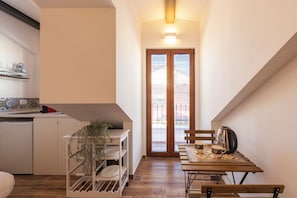 Panoramic Studio, Balcony, City View | Private kitchen | Mini-fridge, stovetop, espresso maker, electric kettle - notaMi - MANSARDE BELVEDERE DUOMO (Milan)