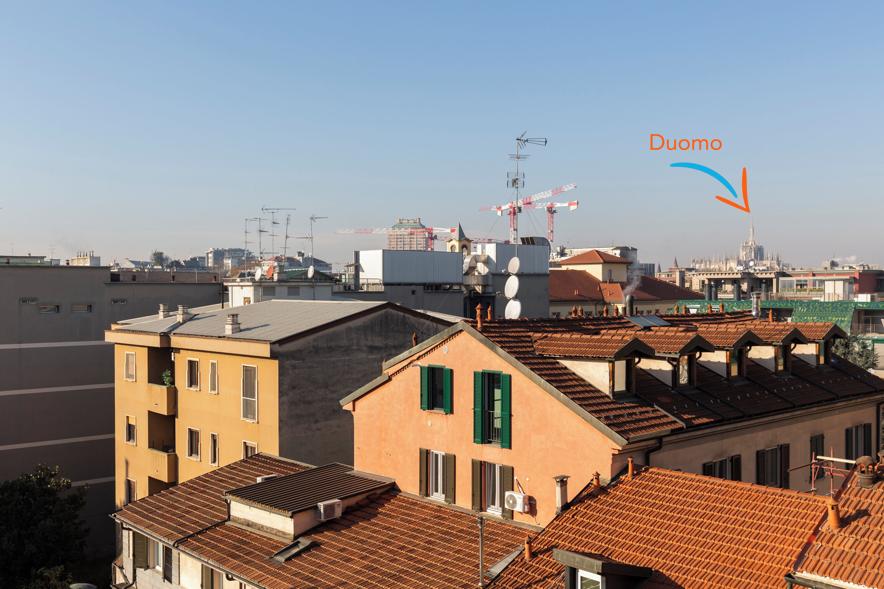 A view of a cityscape with buildings, including a prominent tower labeled "Duomo."