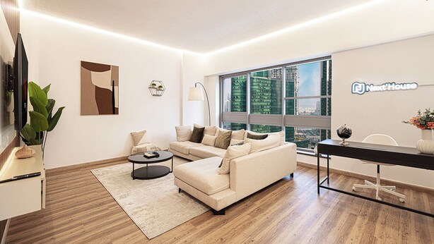 A modern living room with a sofa, coffee table, and a desk with a globe. - Next'House - Business Boulevard Hostel (Dubai)