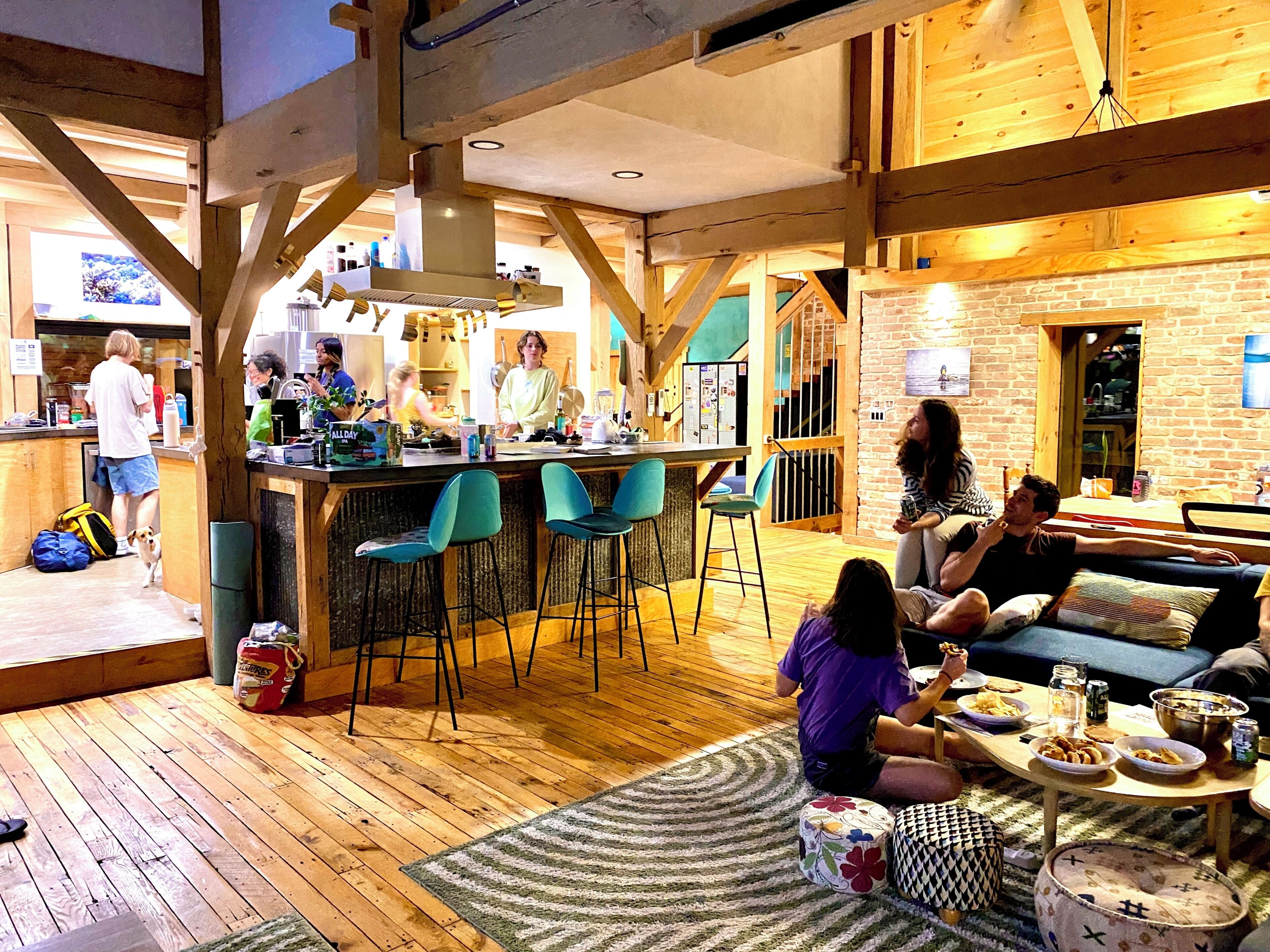 A cozy interior with a bar area, seating, and a kitchen.