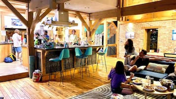 A cozy interior with a bar area, seating, and a kitchen.