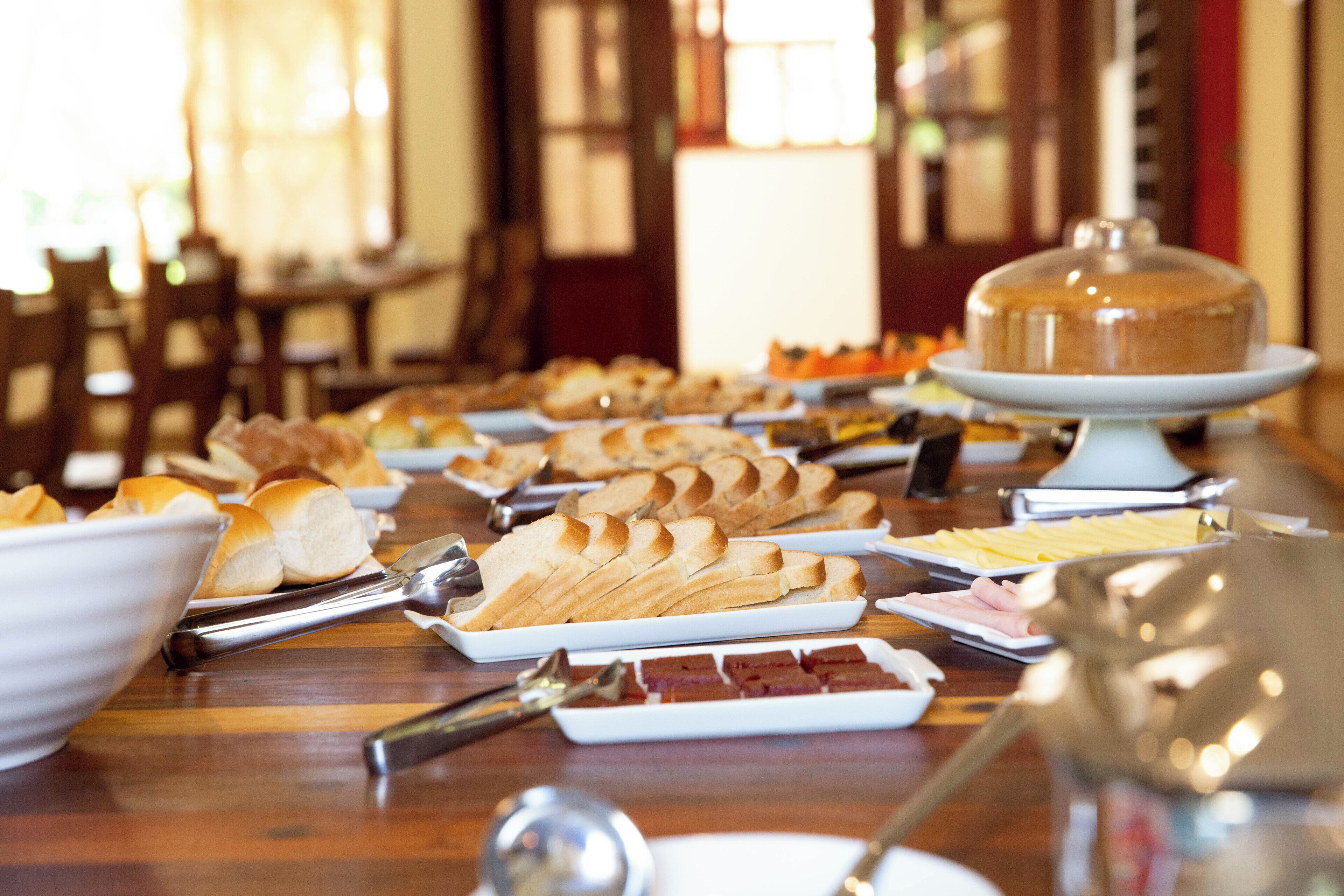 A buffet table with various food items and serving utensils.