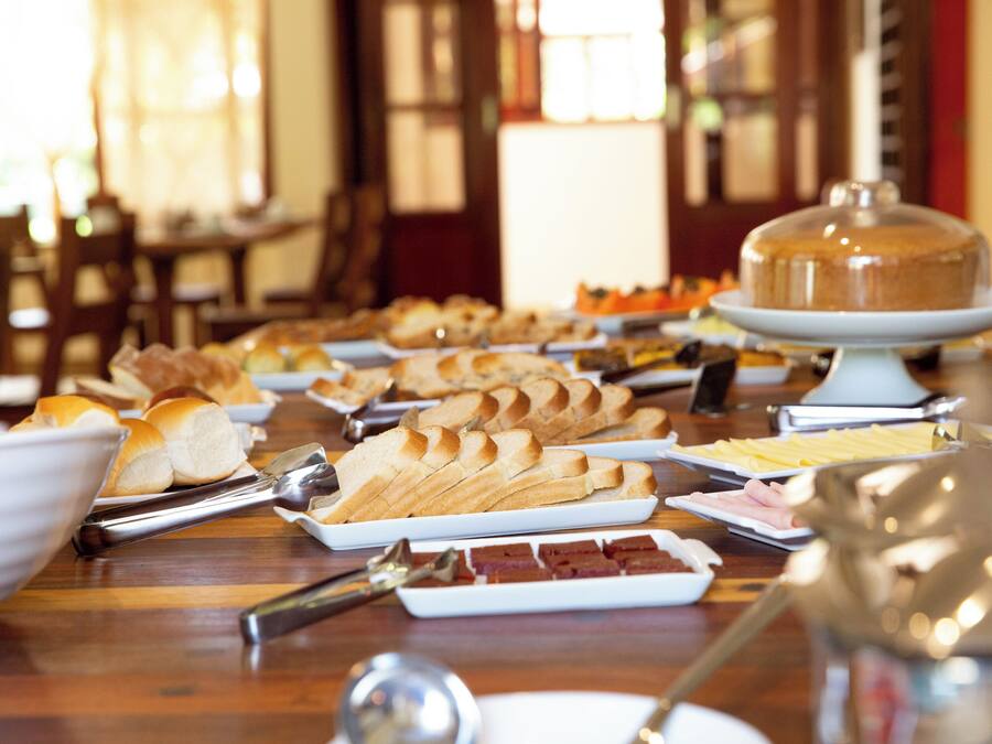 A buffet table with various food items and serving utensils.