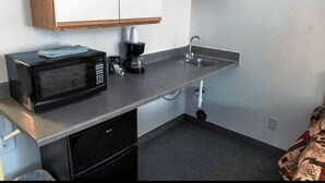 A compact kitchenette with a microwave, coffee maker, and sink. - Coeur D'Alene Budget Saver (Coeur d'Alene)