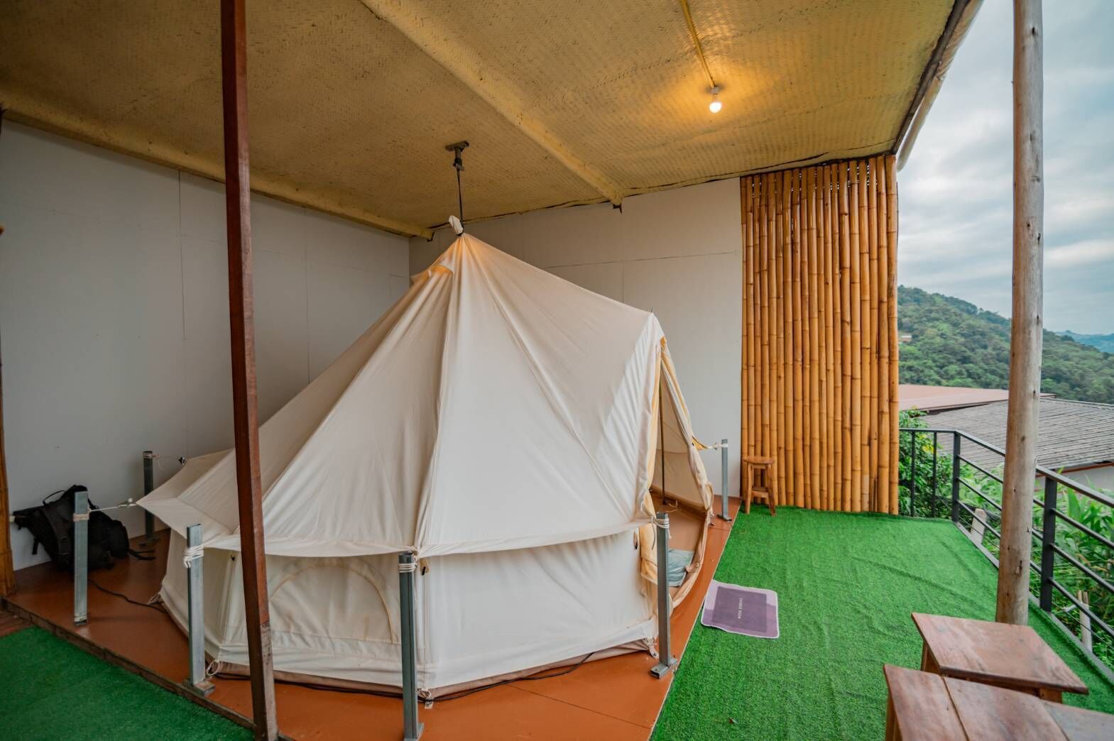 A tented outdoor area with a view of the landscape.