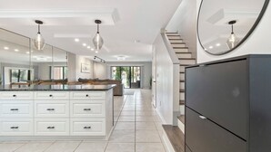A spacious kitchen with a large island, white cabinetry, and modern pendant lighting. - Steps to Beach - 2 MBR-2.5 Bath, Sleeps 6, Gulf Highlands Beach Resort Townhome (Panama City Beach)