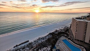 A resort with a pool, beach, and ocean view.
