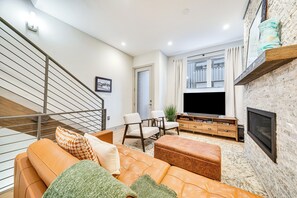 Relax in this stylish living room with a comfortable sofa, flat-screen TV, and wooden coffee table.