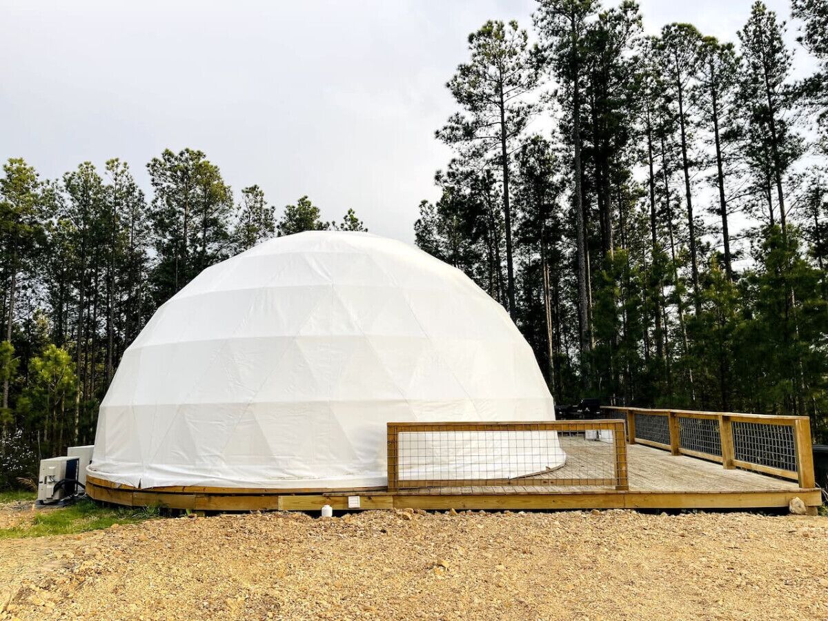 A dome-shaped structure with a wooden deck in front.