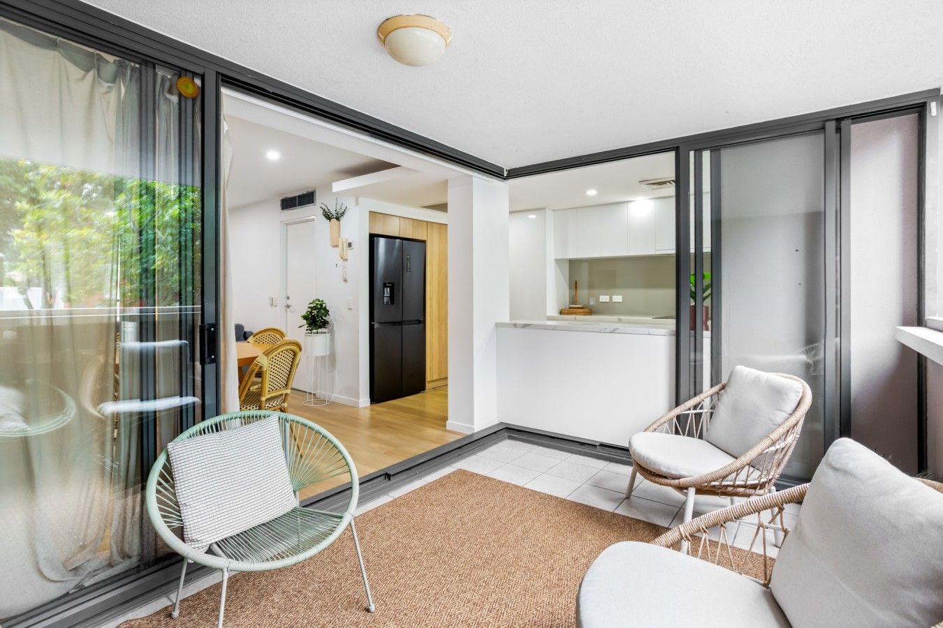 A modern interior with a dining area, kitchen, and seating space.