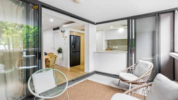 A modern interior with a dining area, kitchen, and seating space.