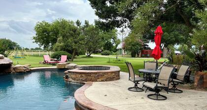 Cozy farmhouse w/pool. Central to museums, golfing, lakes, sports & shopping.