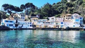 A coastal building complex with multiple levels, likely residential, situated by the water. - A little corner of paradise (Toulon)