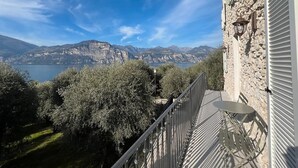 A balcony with a view of a lake and mountains.