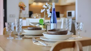 A dining table with plates, bowls, glasses, and a bottle. - Vacation 'Bonita Lajares 3' with Shared Pool, Private Terrace and Wi-Fi (Lajares)