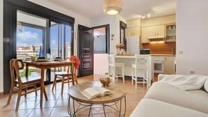 A modern apartment with a dining area, kitchen, and living space. - Vacation 'Bonita Lajares 3' with Shared Pool, Private Terrace and Wi-Fi (Lajares)