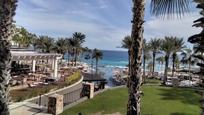 A resort with outdoor seating, a pool, and a view of the ocean. - Ocean view beach suite (San José del Cabo)