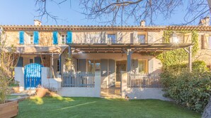 A two-story house with a covered patio, a fenced yard, and a blue gate. - Sainte-Maxime House: Private Terrace, Wi-Fi, and Air Conditioning (Le Plan)
