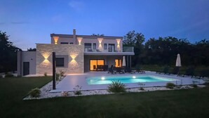 A modern two-story house with a swimming pool, outdoor seating, and a well-maintained garden. - Amazing home in Labin with private swimming pool, can be inside or outside (Labin)