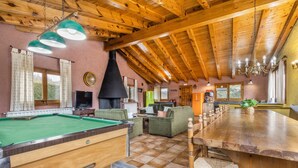 A wooden interior with a pool table, sofas, and a long dining table. - Country House 'Sisquet' with Mountain View, Private Terrace and Wi-Fi (Montcortès)