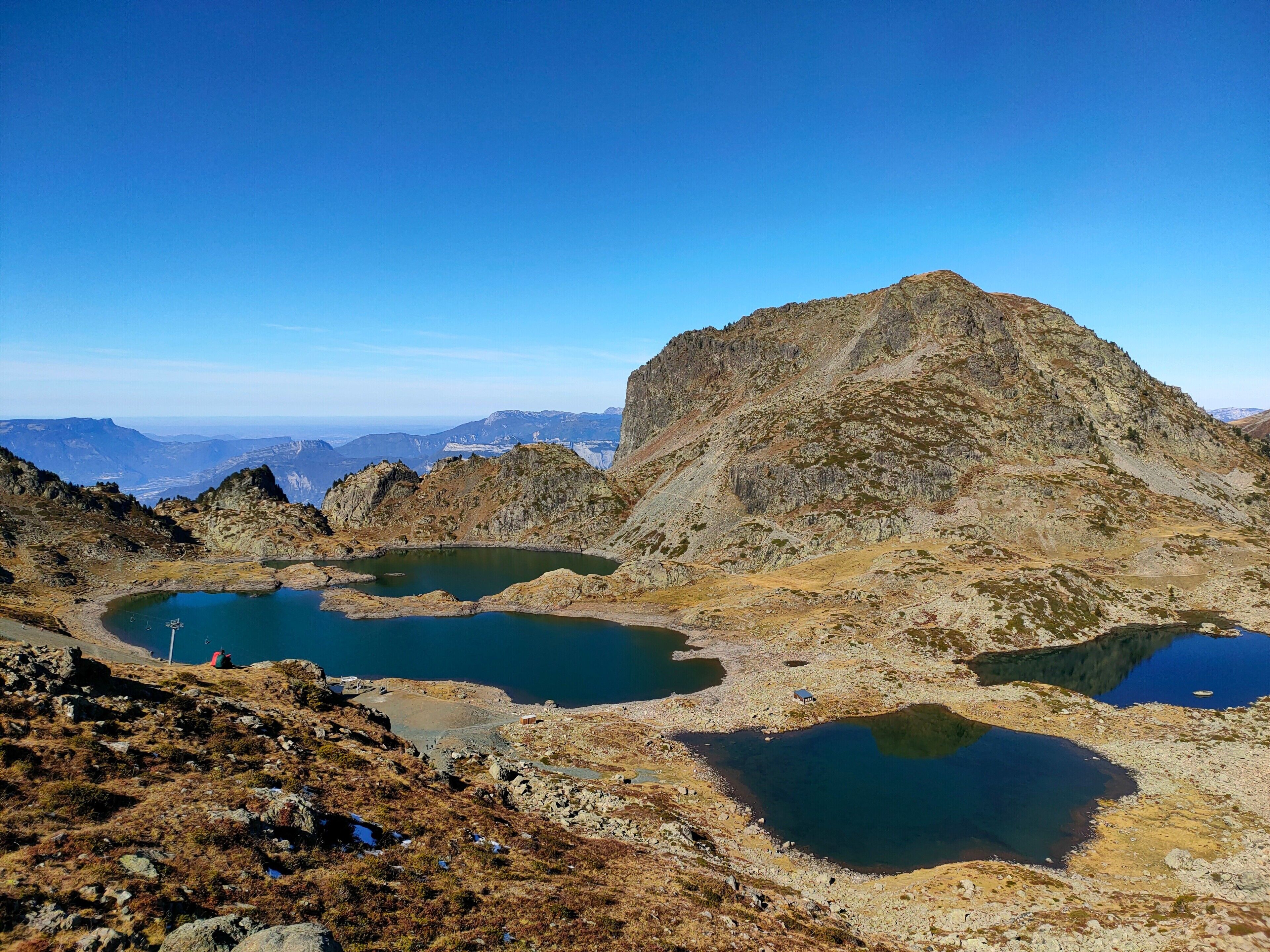 Paesaggio montuoso con numerosi laghi e terreno roccioso.