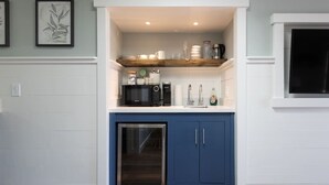 A compact kitchen with a microwave, toaster, and sink.