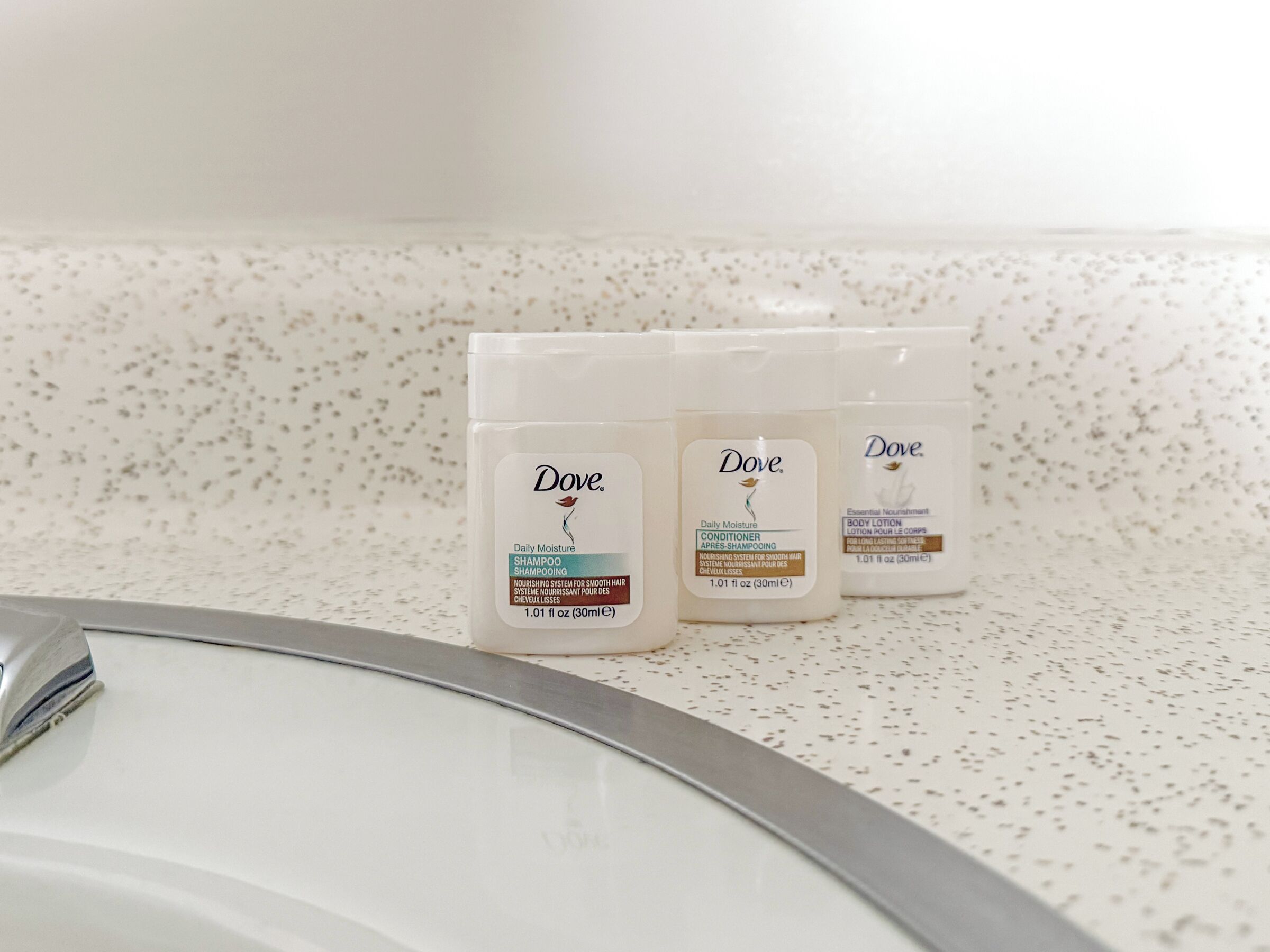 Three Dove products on a speckled countertop.