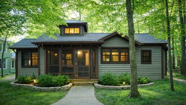 A single-story house with a front porch, a chimney, and a well-maintained lawn.
