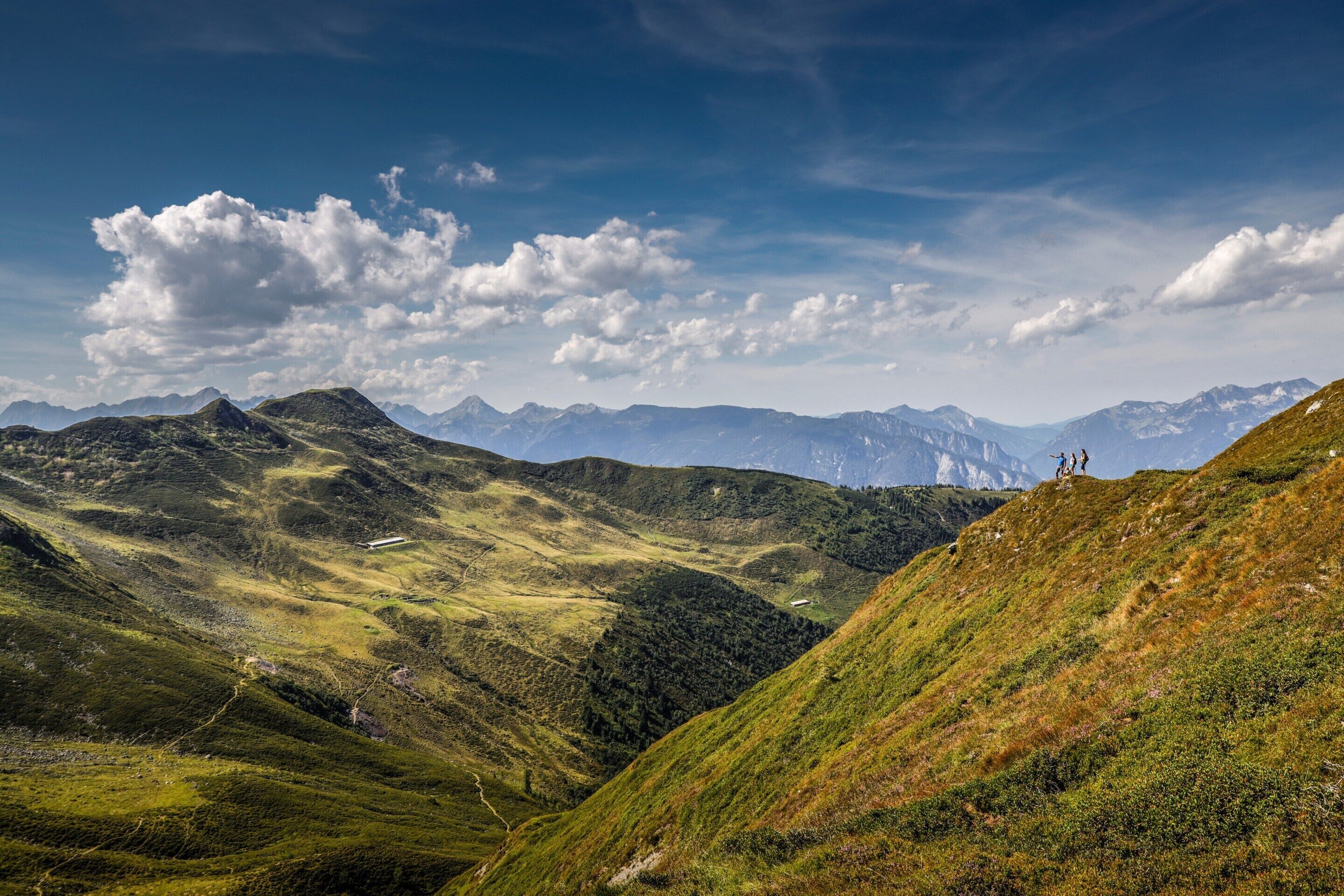 A mountainous landscape with rolling hills and a clear sky.