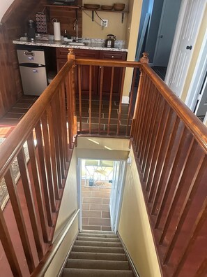 A kitchen with wooden cabinets, a stainless steel refrigerator, and a granite countertop. - Charming 2-bedroom in serene Capitol Heights near Washington DC (Capitol Heights)