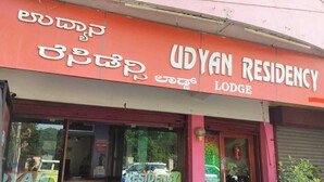 A building with a sign reading "UDYAN RESIDENCY LODGE" in English and another language. - I-ROOMZ Udhyan Residency (Gulbarga)