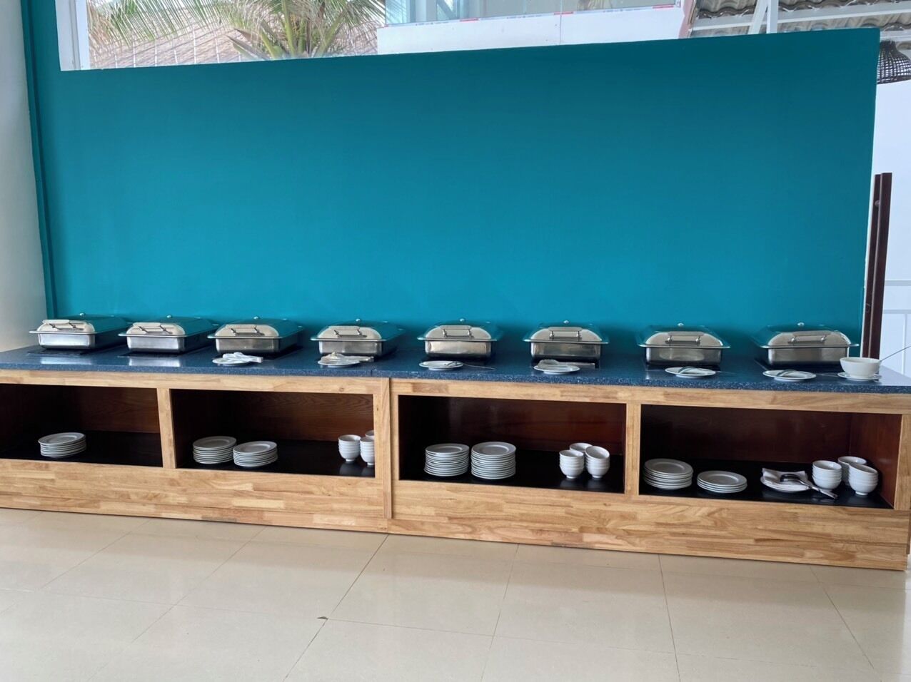 A buffet setup with multiple serving stations and storage shelves.