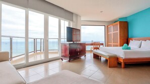 A hotel room with a large balcony, a wooden bed, a TV, and a wooden cabinet. - Mana Mui Ne Beach Resort & Spa (Mui Ne)