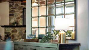 A room with a stone wall, a wooden cabinet with drawers, a window with a metal frame, and a lamp on the cabinet. - Game Room - Hot Tub - Fire Pit - 25 min 2 Yosemite
EV Charger Level 2 (Oakhurst)