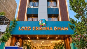 A hotel named 'Lord Krishna Dham' with a modern facade, a prominent entrance, and a well-lit lobby area. - Hotel Lord Krishna Dham (Dwarka)