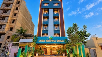 Een hotel met meerdere verdiepingen en een opvallend bord met de tekst 'Lord Krishna Dam'.