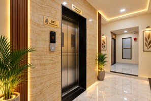 An elevator with a lift button, a sign indicating the second floor, and a security floor. - Hotel Lord Krishna Dham (Dwarka)
