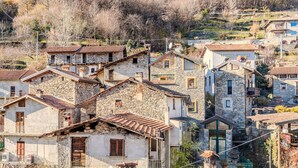 A hillside village with stone buildings, some with balconies, and a clear view of the surrounding hills. - Stunning private villa for 6 people with pool, WIFI, hot tub, A/C, TV, patio and panoramic view (Domaso)