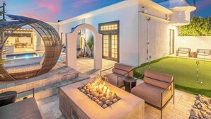 A modern outdoor living area with a fire pit, seating, and a pool. - Casa Del Sol Luxe Experience - Walkable 2 Old Town (Paradise Valley)