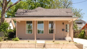 A single-story house with a front porch, a garage, and a small front yard. - Stylish Home Nr DT, Alamo, River Walk | Games WiFi (San Antonio)
