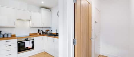 Fridge, electric kettle, cookware/dishes/utensils, dining tables