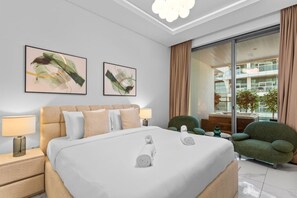 A modern hotel room with a large bed, two side tables, a green armchair, and a view of the city through large windows. - Lush Living w jacuzzi and Burj Khalifa view (Dubai)