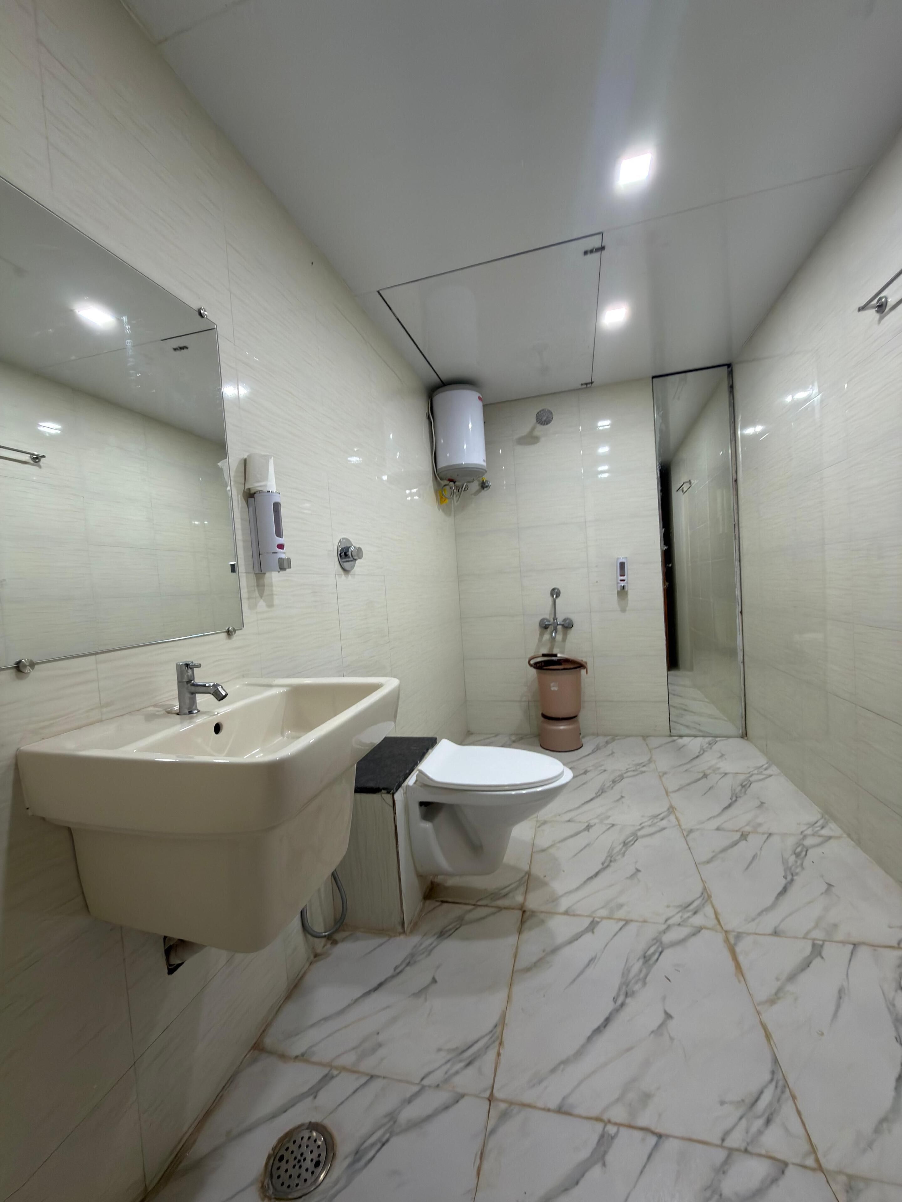 A bathroom with a sink, toilet, and shower.