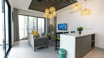 Family Triple Room, Garden View | Living area | TV