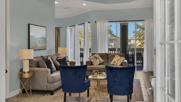 A living room with a sofa, two armchairs, a coffee table, and a lamp. - Spacious 3-Bedroom Retreat with Lake Views (Miramar Beach)